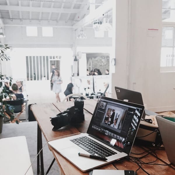 Open laptop on a desk with a cozy home setting, symbolizing remote work and earning money from home