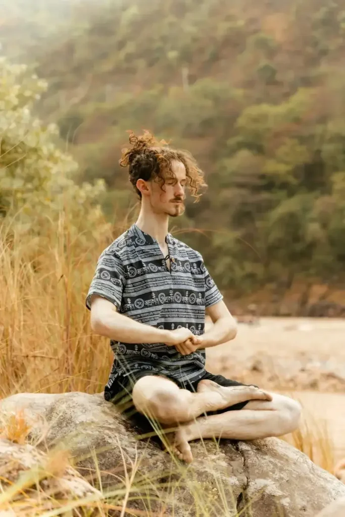 Person is meditating after listening to The Billionaire Brain Wave program